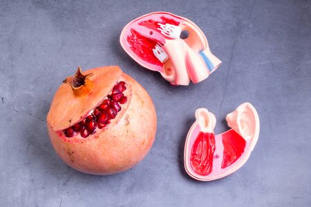 red juicy pomegranate and heart shape, healthy food