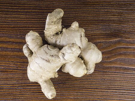 Fresh ginger root on wooden table background, antivir. Naturally elevating your energy levels, close...