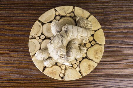 Fresh ginger root on wooden table background, antivir. Naturally elevating your energy levels, close upの写真素材