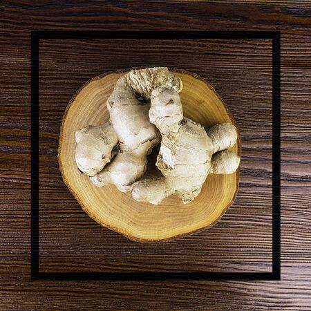 Fresh ginger root on wooden table background, antivir. Naturally elevating your energy levels, close...