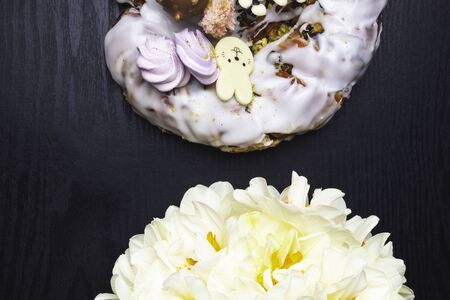 easter cake, decorative chocolate bunny, narcissus flower on wooden tableの写真素材