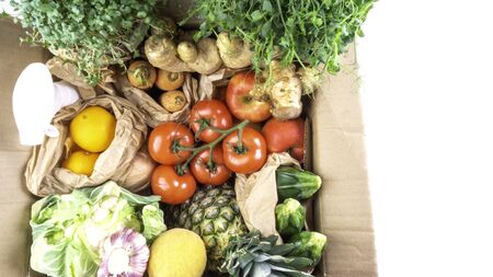 Grocery zerto waste paper box with organic healthy food clean eating selection, fruits, microgreens, vegetables, green leaf. Food rich in fiber, vitamin, antioxidants, copy space, bannerの写真素材