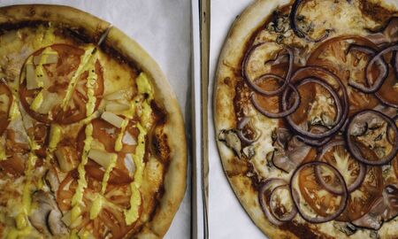 pizza in the in delivery box, different delicious pizzas with variety of toppings and cheese in cardboard take out boxes, close up. Pizza delivery or menu conceptの写真素材