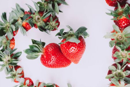 ripe red whole fresh strawberries with green stalks , view from above, close up, postcard, selective focus, creative tonedの写真素材