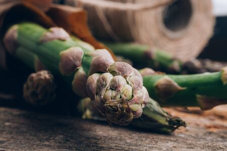 Bunch of fresh asparagus on wooden table, selective focusの写真素材