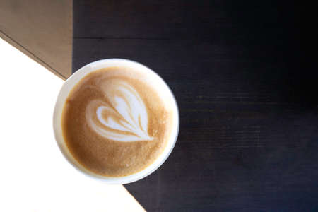 love cup with heart drawing on latte heart figure art, for Valentines Day. Top view, copy space