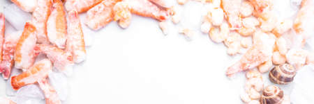 assortment of frozen seafood on ice cubes, shrimps, Babylonia areolata shellfish snails,...