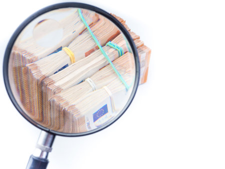 magnifying glass on 50 Euro cash banknotes. European money, fake money, currency, debt, economy and financial analysis concept.の写真素材