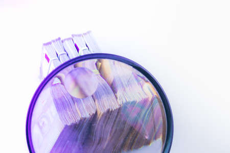 magnifying glass on 50 Euro cash banknotes. European money, fake money, currency, debt, economy and financial analysis concept.の写真素材