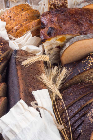 assortment of fresh baked bread, still life, traditional bread and wheat, rye, wheat bread. Vegeterain foodの写真素材