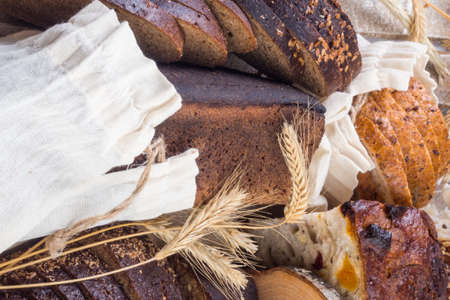 assortment of fresh baked bread, still life, traditional bread and wheat, rye, wheat bread. Vegeterain foodの写真素材
