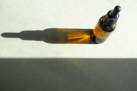 Serum or oil for skin with liquid, collagen and peptides with trendy shadows, glass bottle with...