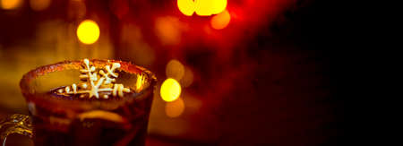 Mulled Christmas wine with orange, spices and snowflake gingerbread cake.の写真素材