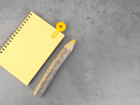 yellow notebook, wooden pencil on the ultimate gray background. To do list. Flat lay design with copy space. Color 2021の写真素材