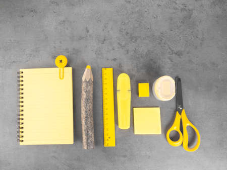 office desk with accessories background on trendy colors, school yellow supplies on a ultimate gray background. Flat lay, top view. Back to school concept. Copy space for you textの写真素材