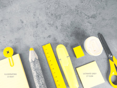 office desk with accessories background on trendy colors, school yellow supplies on a ultimate gray background. Flat lay, top view. Back to school concept. Copy space for you textの写真素材