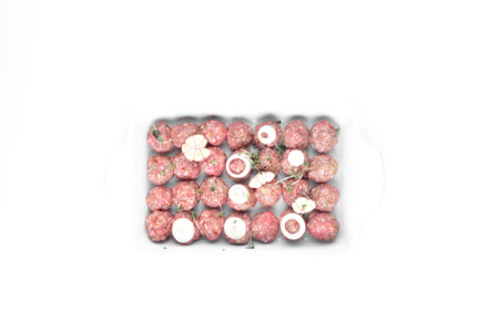 homemade raw organic mincet meat balls with onion, garlic, micro greens, uncooked, isolated on white, close up. Chinese foodの写真素材