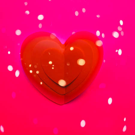 Background with one paper heart origami, Valentine greeting card or Happy Valentine's Day with lights, love concept. Handcrafted designed card expressing love.の写真素材