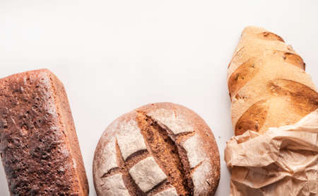 Mixed whole grain health breads with flour isolated on white background