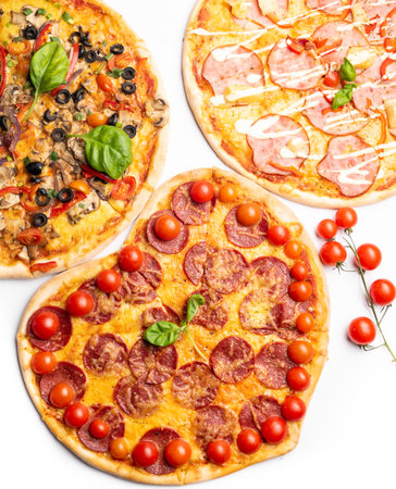 different various kind of pizzas in assortment with green basil, mushrooms, tomatoes, cheese, pepper for menu. Close up. Fast food or pizza party dinner, lunch, celebration or gathering concept.の写真素材