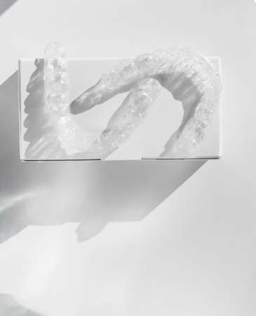 Tranparent Braces. Invisible aligners for fixing teeth after alignment on white medical background, copy spaceの写真素材