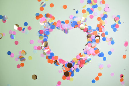 A heart formed from multicolored petals. Pastel backgroundの写真素材