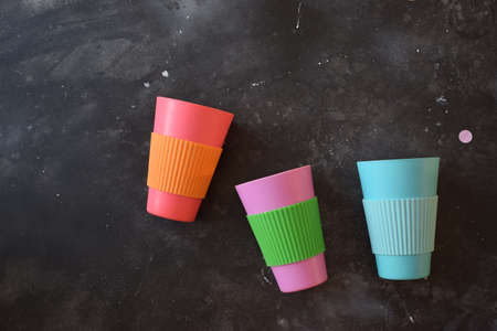 Colorful plastic cups in a black backgroundの写真素材