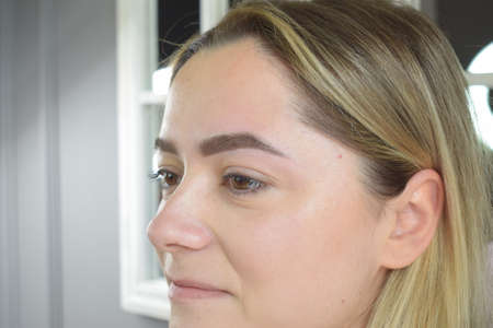 Young Caucasian woman for beauty procedures, permanent eyebrow makeupの写真素材