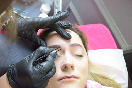Young Caucasian woman for beauty procedures, permanent eyebrow makeupの写真素材