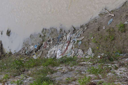 Plastic waste in the river in the center of the cityの写真素材