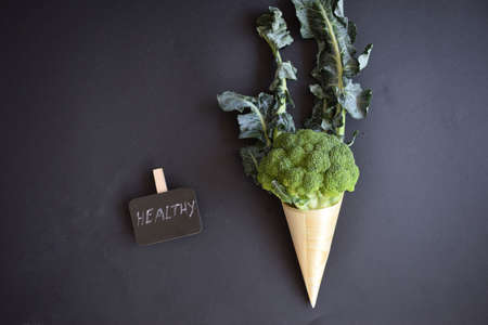 Fresh green broccoli in a wooden coneの写真素材