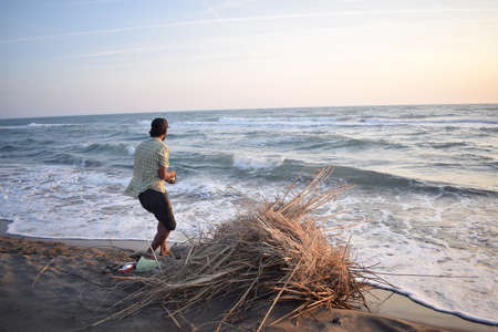 The fisherman is fishing in a rough seaの写真素材