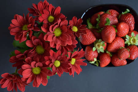 A ration of fresh strawberries on a black backgroundの写真素材