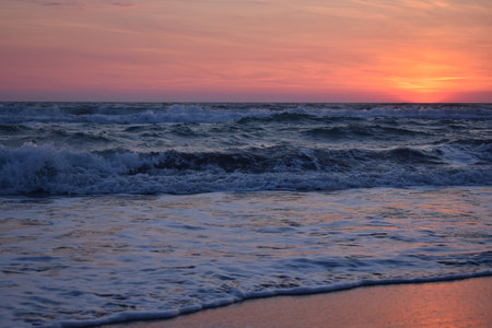 A beautiful sunset on the beach in the turbulent ocean