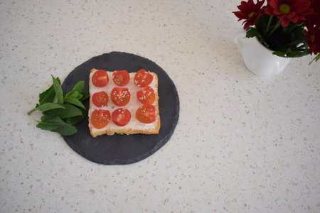 Healthy breakfast toast with tomatoes, ricotta and herbsの写真素材