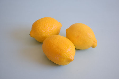Fresh lemons on a blue backgroundの写真素材