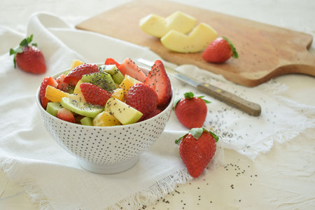 Bowl of fresh fruit salad, kiwi, apples, oranges.の写真素材