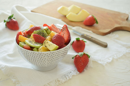 Bowl of fresh fruit salad, kiwi, apples, orangesの写真素材