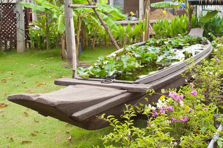 Traditional Thai boat decorate in the garden filling with a lot of Lotus, Ayuthayaの写真素材