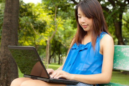 Young girl get her information for work with her notebook at outdoorの写真素材