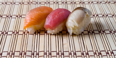 Japanese tradition food, Sushi  made of salmon, seaweed, tuna  and mackerel with  rice on wood  bamboo  matの写真素材