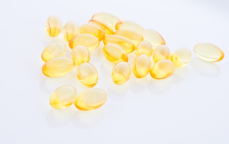 Fish oil pill on white background