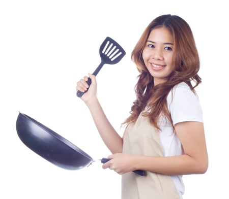 Beautiful blonde woman housewife holding pan on white backgroundの写真素材