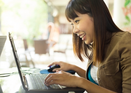 Young woman using notebook laptop at outdoorの写真素材