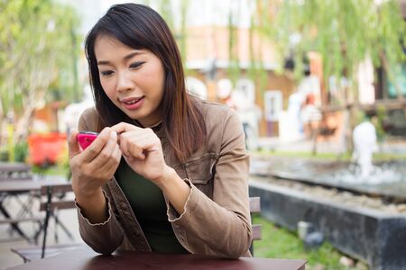 Woman texting message  on mobile phone at outdoor