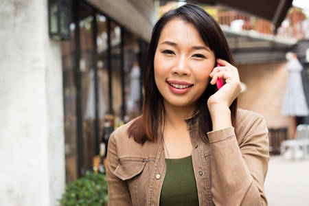 Woman talking on mobile phone at outdoorの写真素材