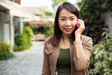 Woman talking on mobile phone at outdoorの写真素材