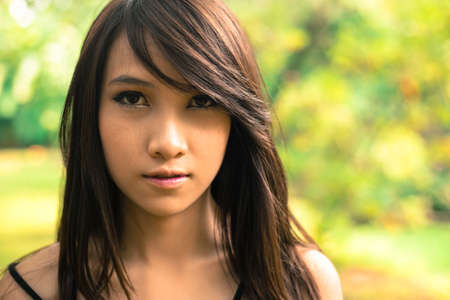 Beauty young woman headshot in natureの写真素材
