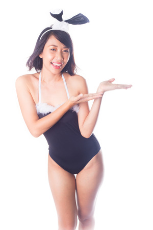 Sexy bunny girl presenting on white backgroundの写真素材