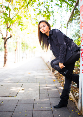 Beautiful young woman walking down the street in the cityの写真素材